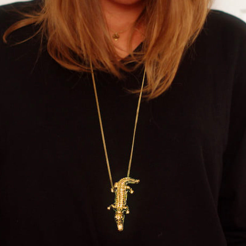 Bijou clip en forme de crocodile doré porté en pendentif collier