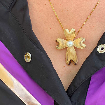 Bijou clip en forme de croix maltaise dorée avec perle porté en pendentif colllier